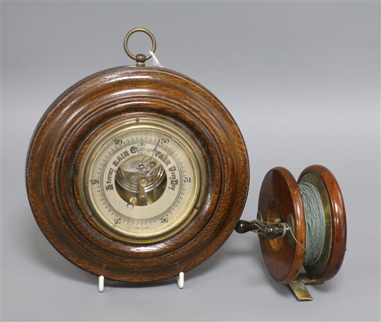 A J. Marshall fishing reel and an aneroid barometer